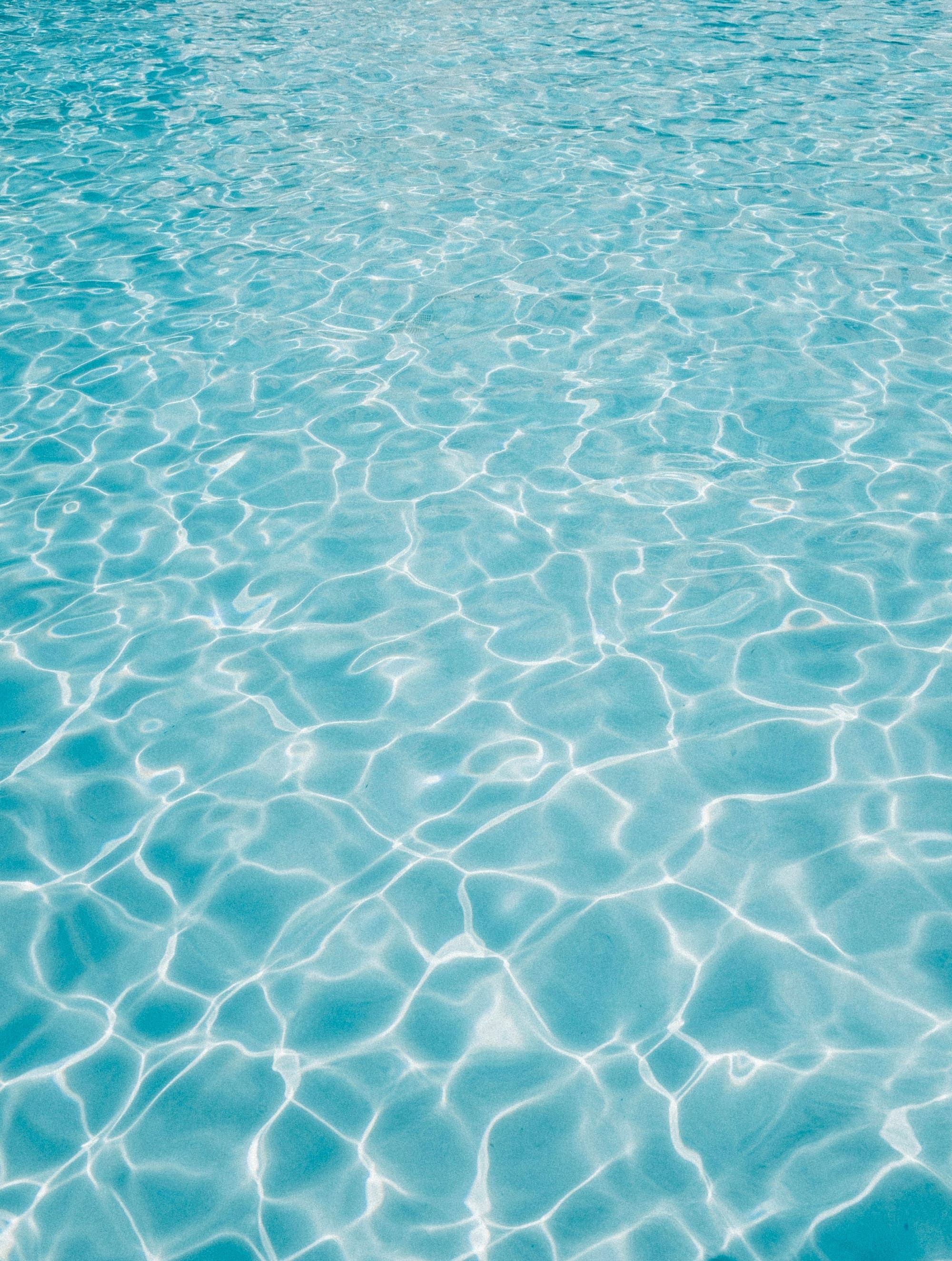 Close-up of crystal blue rippling pool water
